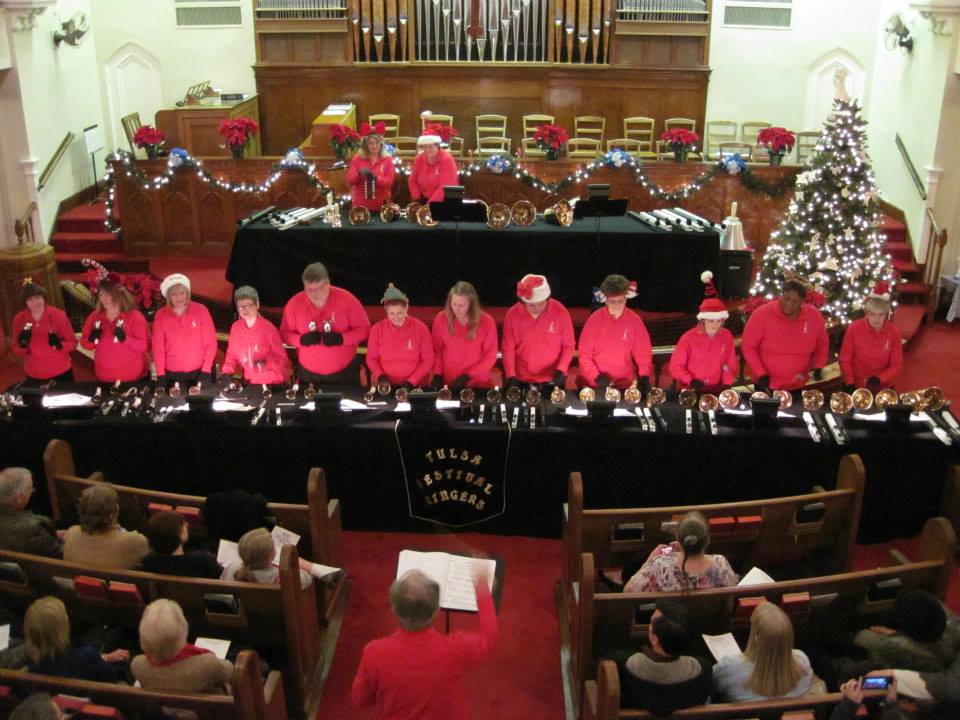 The ensemble in red shirts mid-performance